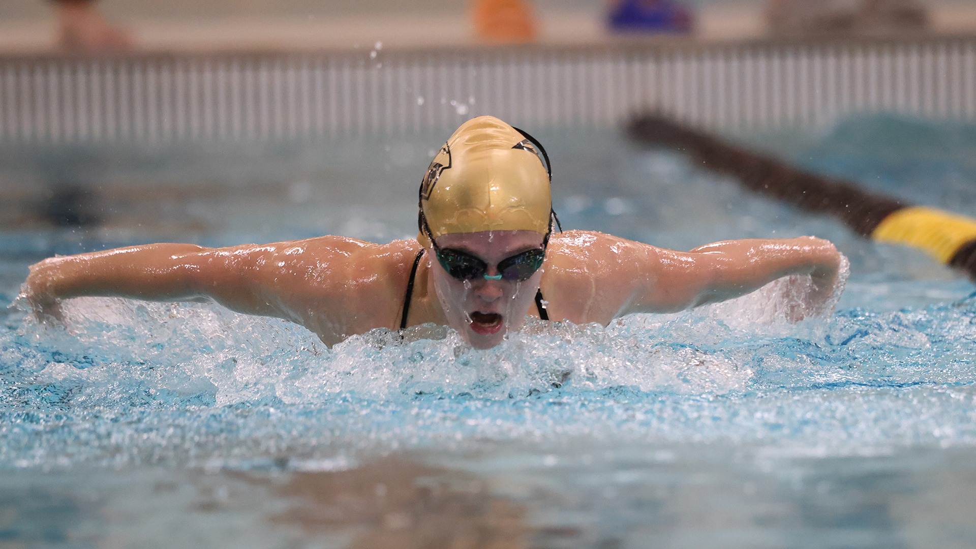 2025 Brianna Wesenberg Action Shot, swimming the butterfly against Carroll
