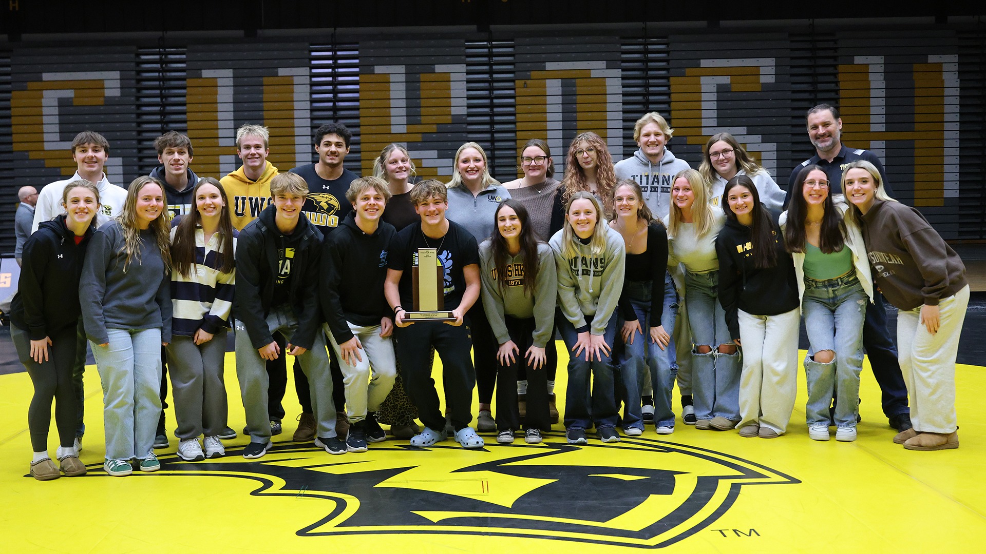 2025 Swimming & Diving Take Down Hunger Team Photo with Trophy