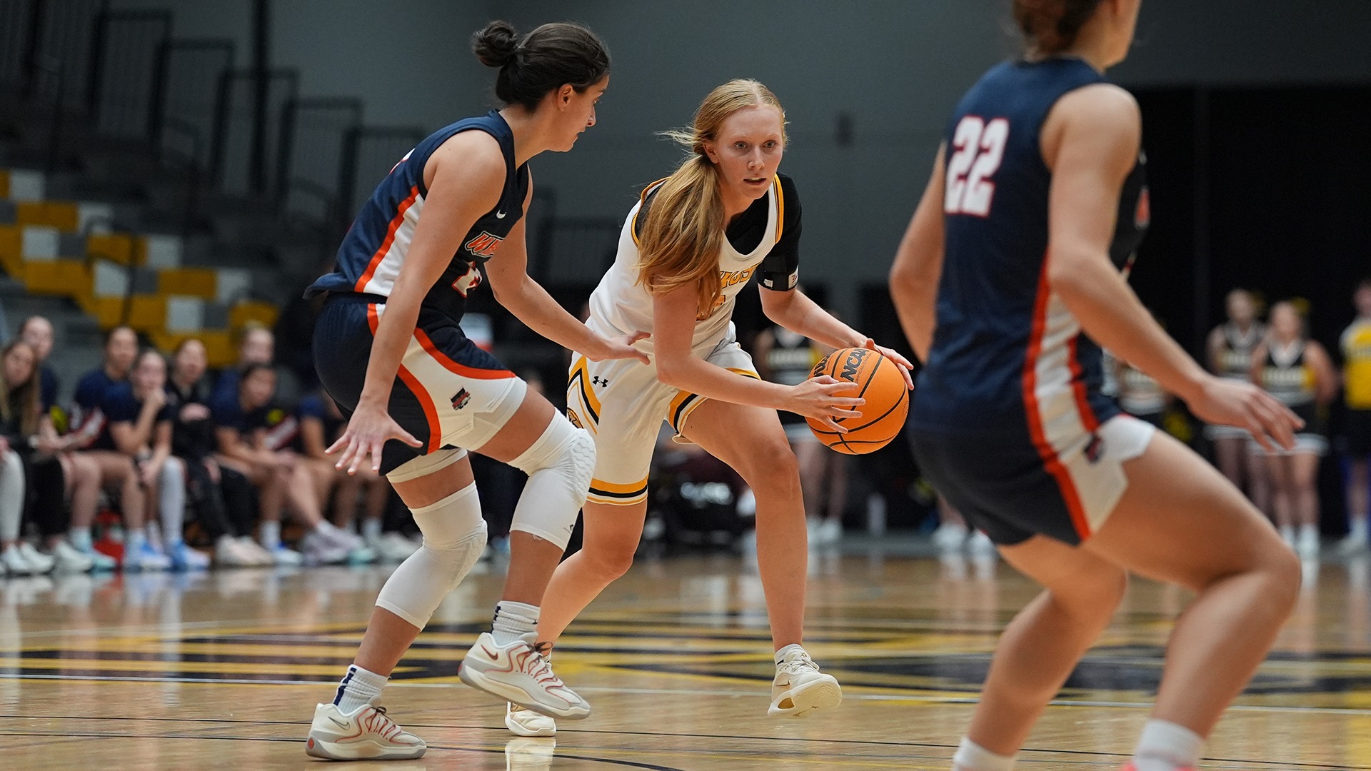 2025 Olivia Argall Action Shot, dribbling towards a Wheaton defender