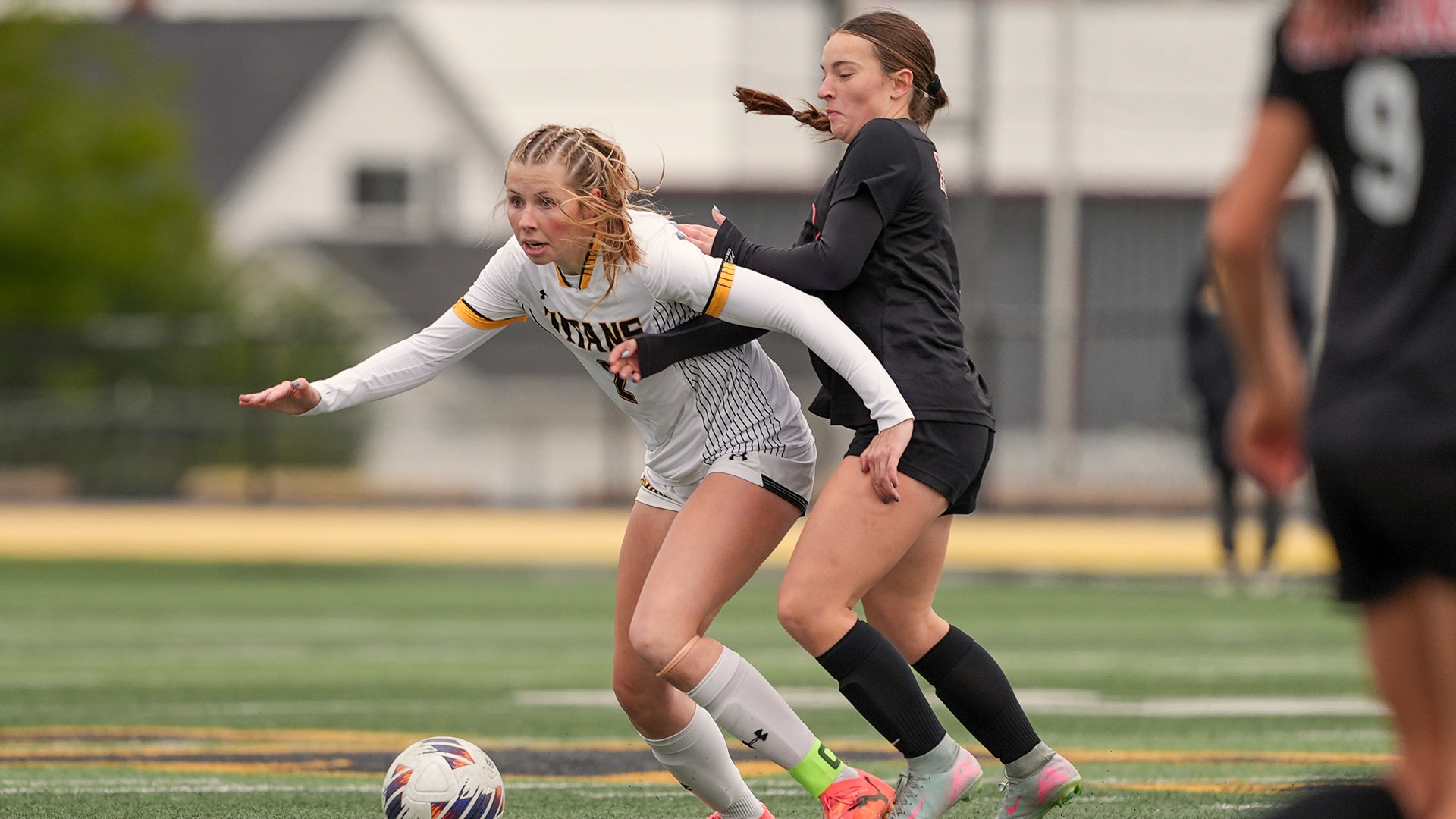 2025 Delaney Sponholz Action Shot, dribbling the ball around a defender against River Falls