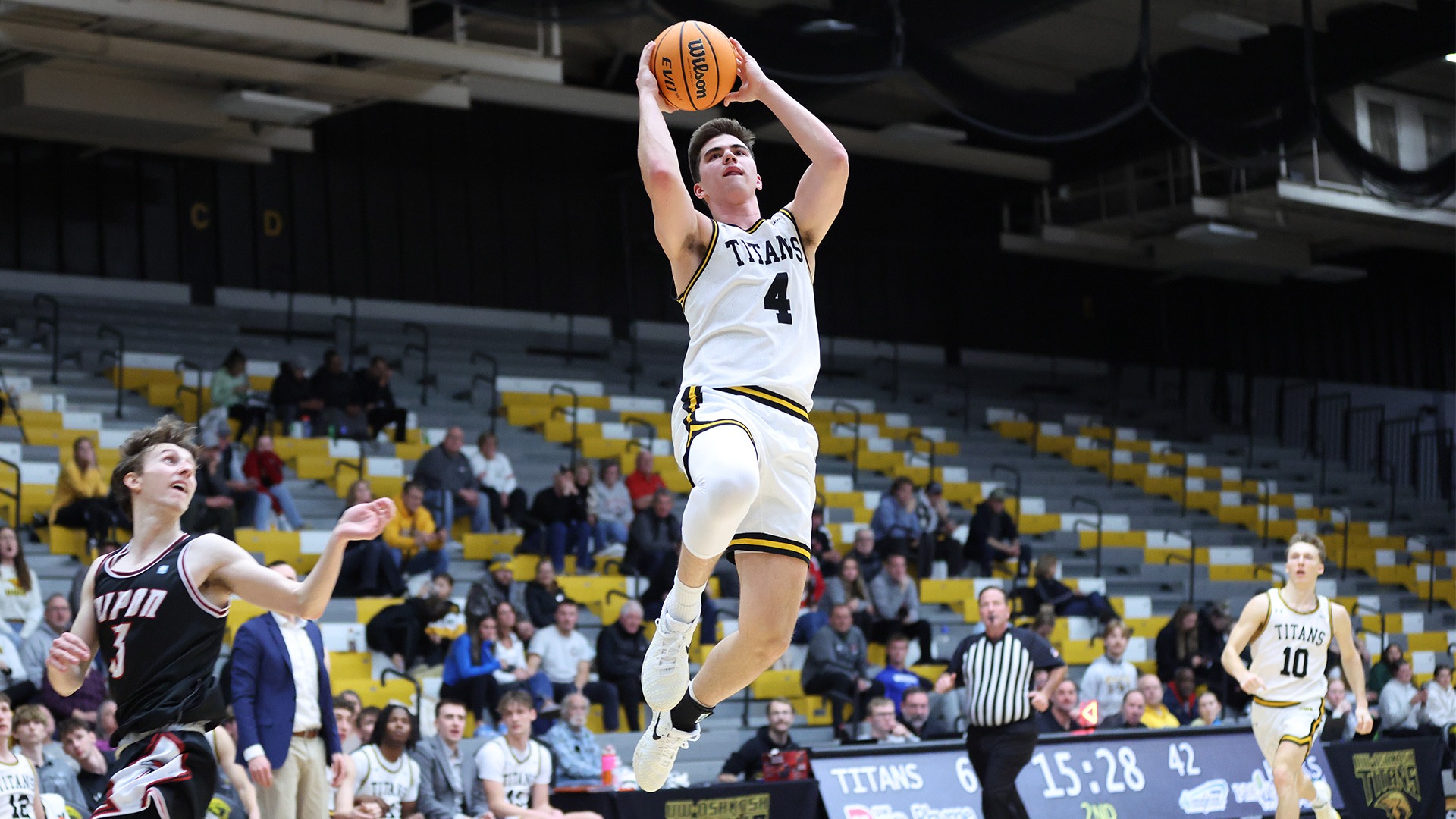 2025 Michael Metcalf-Grassman Action Shot, going up for a layup against Ripon