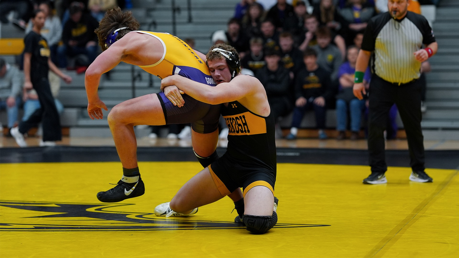 2025 Garrett Fuller Action Shot, taking down his opponent against Stevens Point