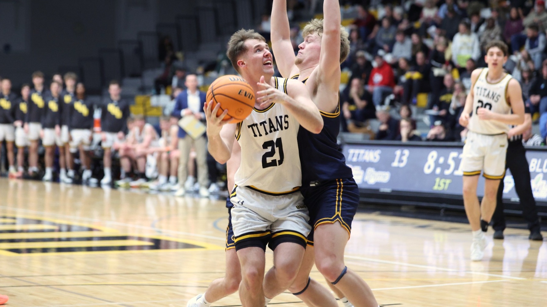 2026 Carter Thomas Action Shot, going up for a layup against an Eau Claire defender