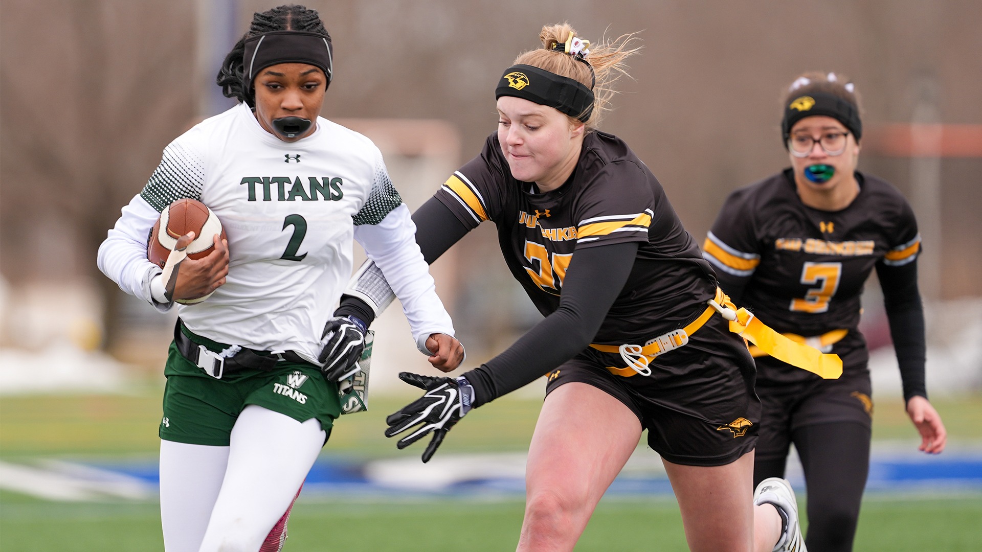 2026 Paige Vitek Action Shot, pulling an Illinois Wesleyan ball carrier's flag