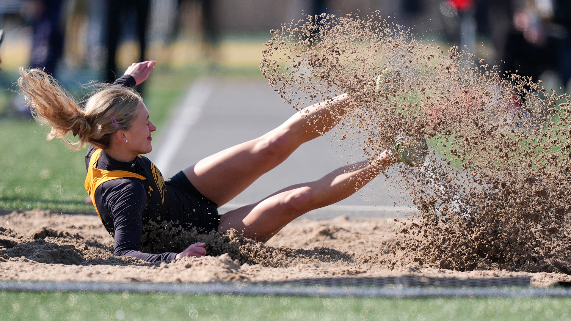 2026 Anna Bubolz Action Shot, competing in the long jump in the Oshkosh Titan Invitational