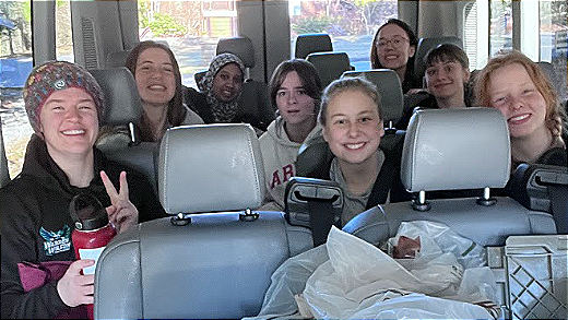 The 2022-2023 Warren Wilson Swim Team in the van ahead of the swim meet on 1/27/23