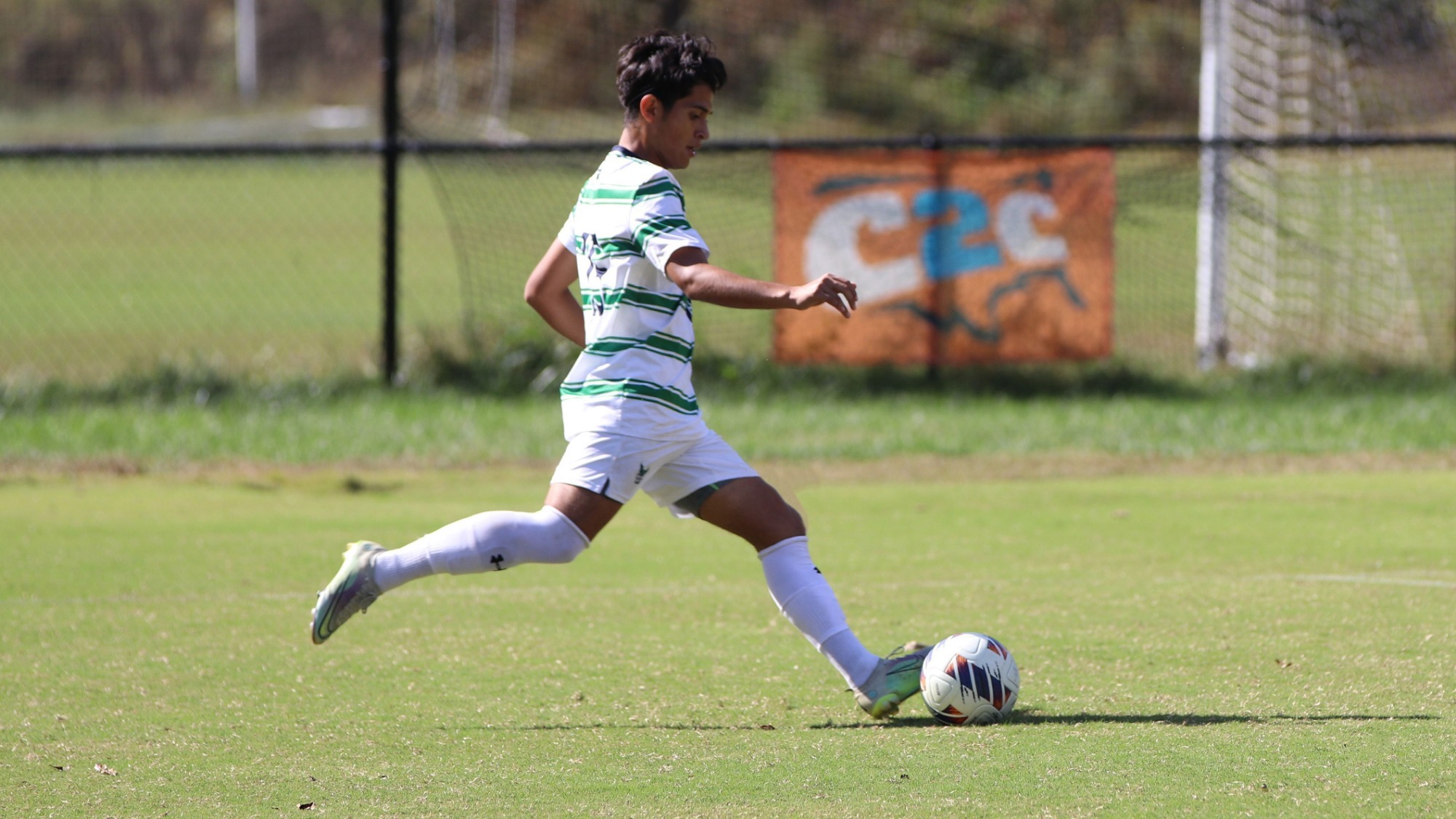 2023 Men's Soccer player, Moises Diaz, shoots the ball towards the goal
