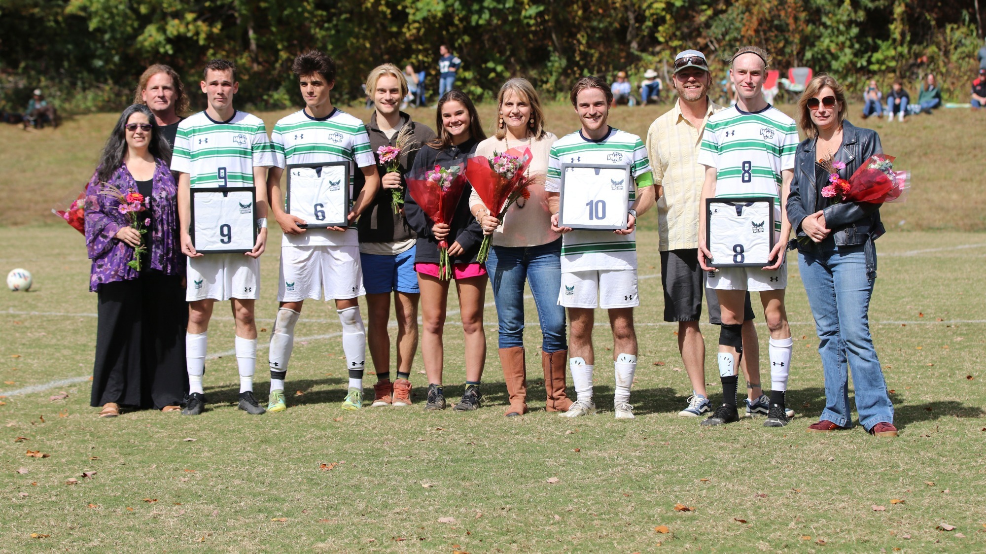 2023 Men's Soccer Senior Players, their families and coaches are lined up for a photograph