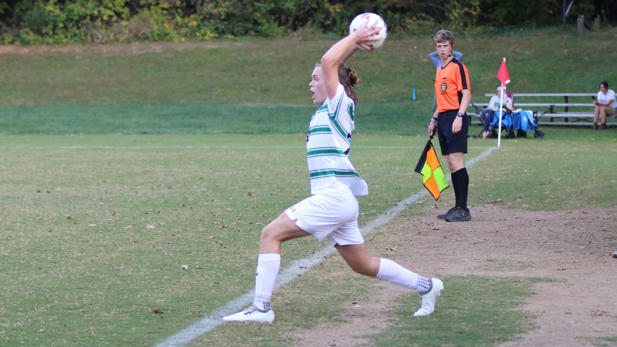2023 Men's Soccer Player, William Bush throws the ball in bounds from the sideline.