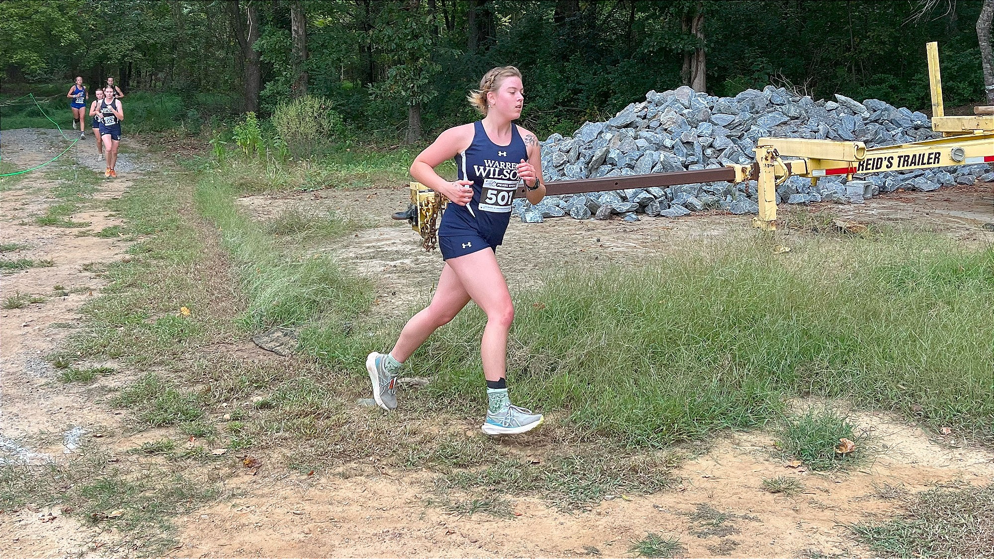 Women's Cross Country runner is running course in Yeti Invitational