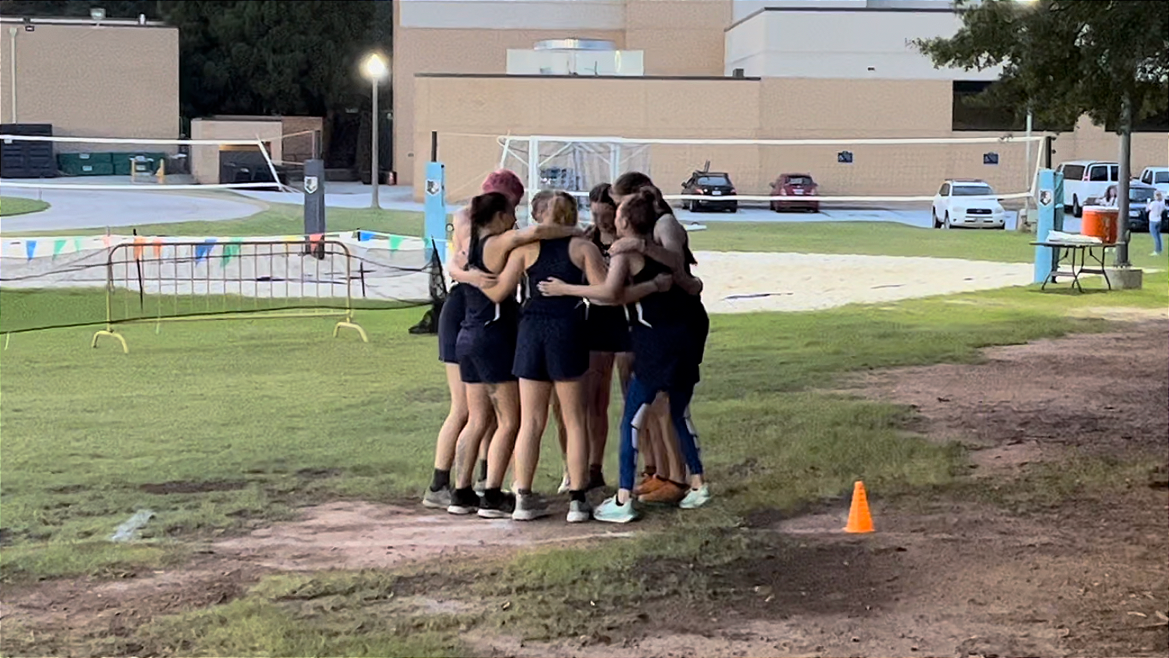 Warren Wilson's Cross Country Team gathers in a huddle before the race