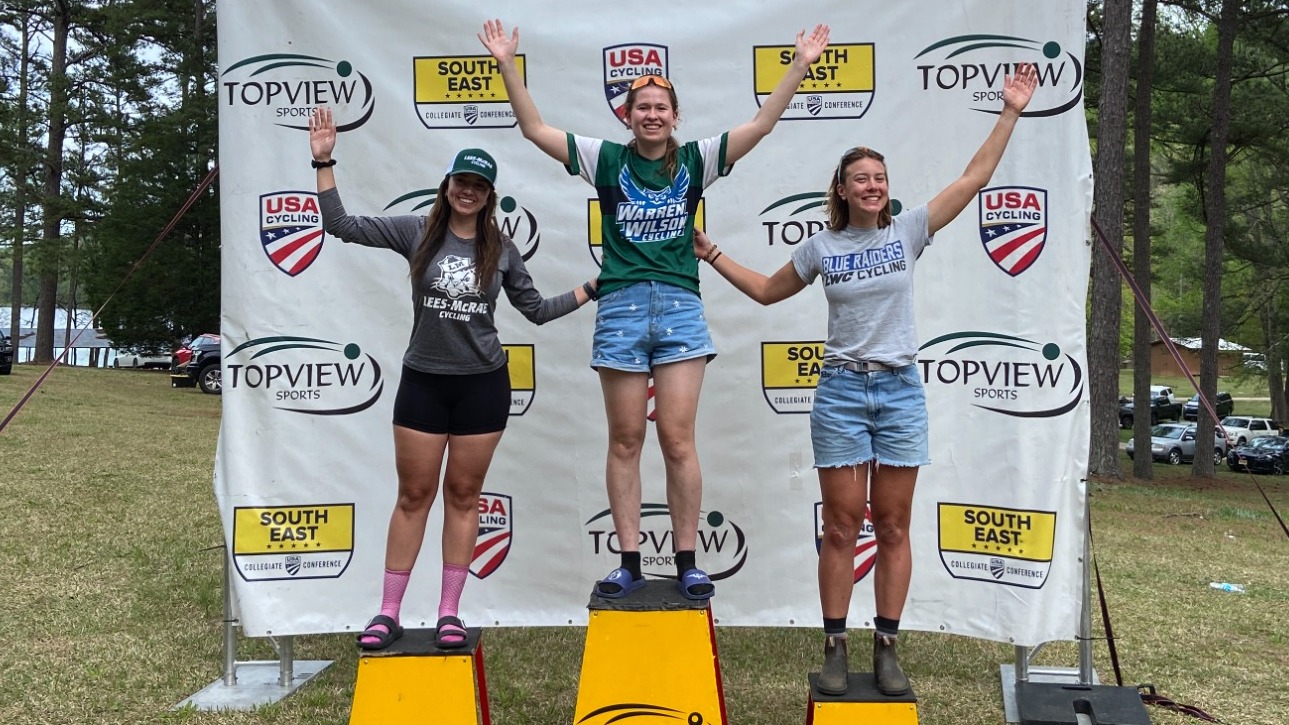 Liselot Voordouw, a member of the 2024 Cycling Team, Stands on the Podium in first place after her race.