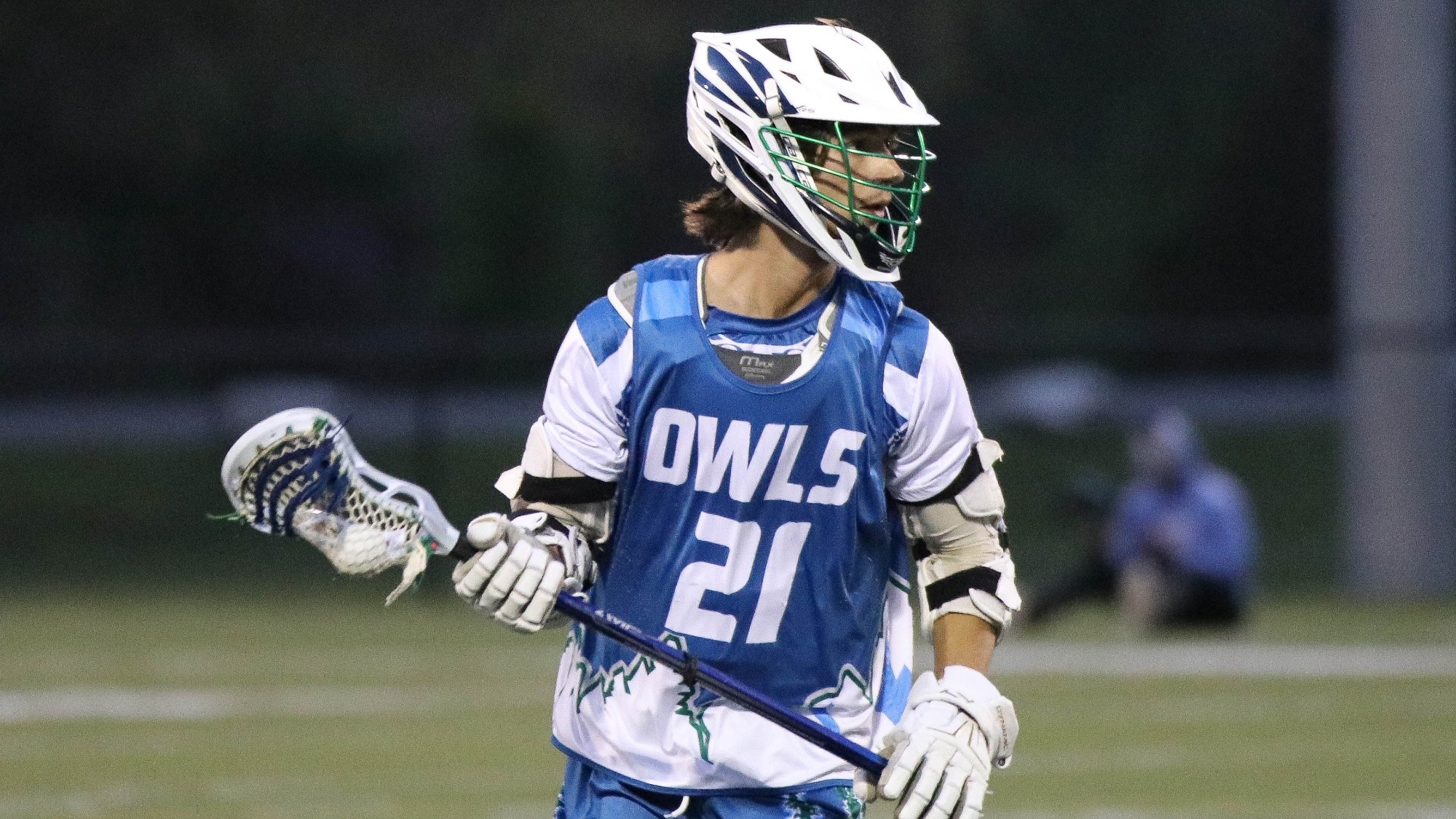 Timmy Carcel holds the lacrosse ball in his stick on offense.