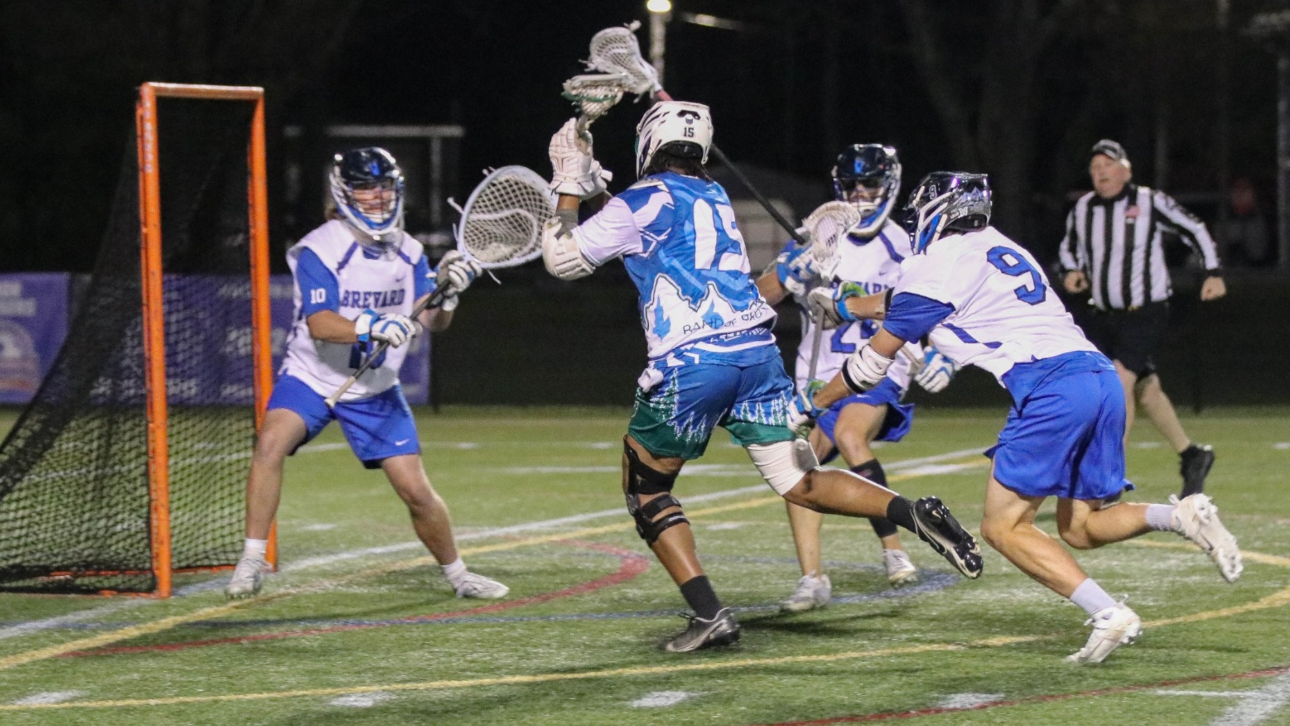 Men's Lacrosse player, Saiquan Bell, shoots and scores a goal into the opposing goal.