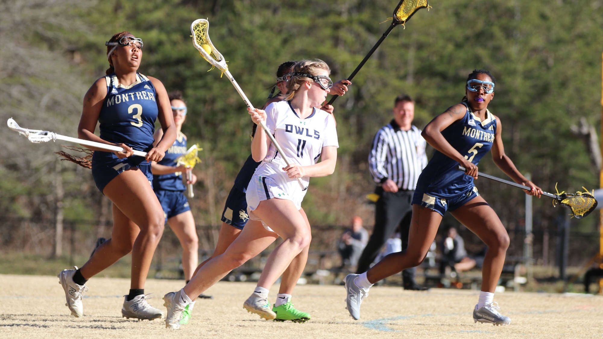 Women's lacrosse player, Sophia Spangler carries the ball down the field.