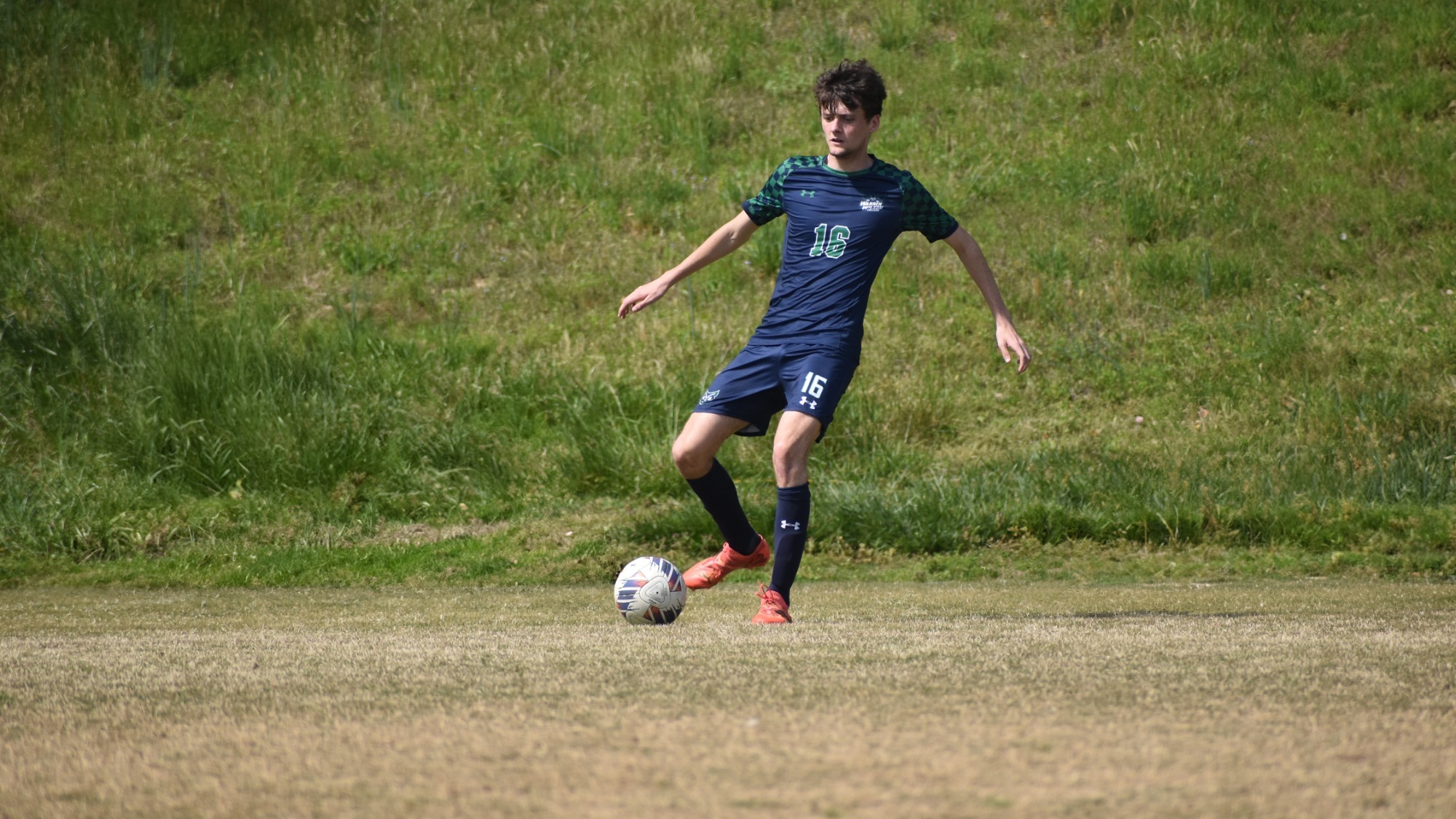 Warren Wilson player passes the soccer ball to a teammate.